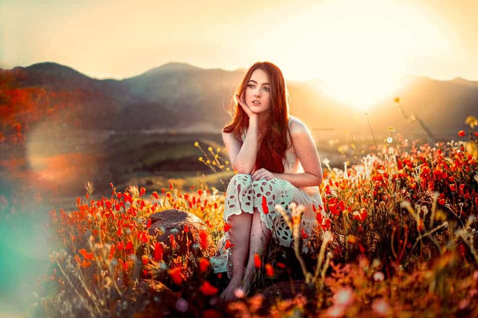 A girl sitting in a beautiful sunshine place bright